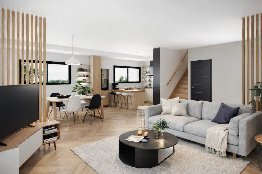 Pièce de vie ouverte d’une maison moderne CELIA Création avec salon, salle à manger et cuisine, intérieur lumineux d’une maison sur-mesure dans le sud-ouest.